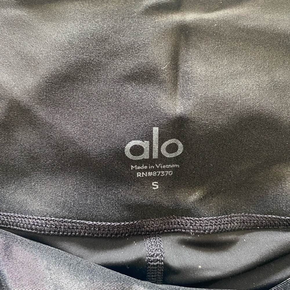 Black, shiny, Alo Yoga leggings.